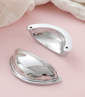 Front and back views of the solid brass open-back cup pull in Polished Chrome, showing its reflective face and two mounting holes.