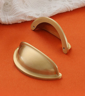 Front and rear views of the solid brass open-back cup pull in Satin Brass, showing two rear mounting holes.