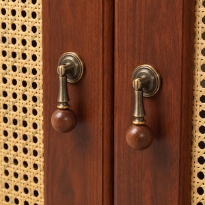 In-use view of dark wood ball drop pull with antique bronze brass mount, style #11.