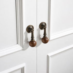 In-use view of coffee-finish drop pull with dark wood ball end, style #4 Coffee.