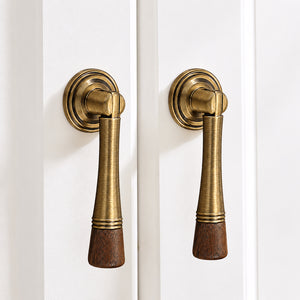In-use view of dark wood-ended bronze-finish drop pull with round mounting plate, style #7 Bronze (76 mm).