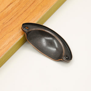 Rear view of the raised-rim half-moon iron cup pull in Antique Copper, showing the recessed back and two mounting holes.