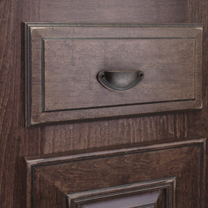 Raised-rim half-moon iron cup pull in Antique Copper on a dark wood-grain drawer.