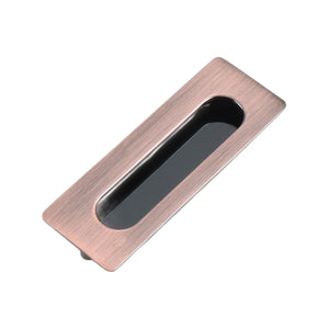 Reddish bronze-tone rectangular recessed cabinet pull with a dark finger grip, 106 mm.