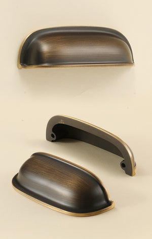 Front, rear and angled views of the solid brass rounded dome cup pull in Antique Bronze.