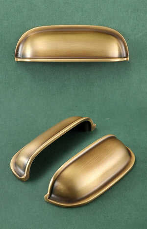 Front, underside and angled views of the solid brass rounded dome cup pull in Burnished Brass.