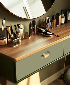 Solid brass soft-corner cup pull in Aged Brass on a green dressing-table drawer.