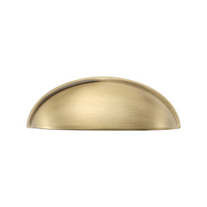 Solid brass half-moon cup pull in burnished brass, front view on white.