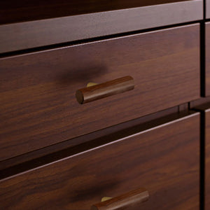 In-use view of slim walnut wood T-bar cabinet pull with brass stem, style #8.