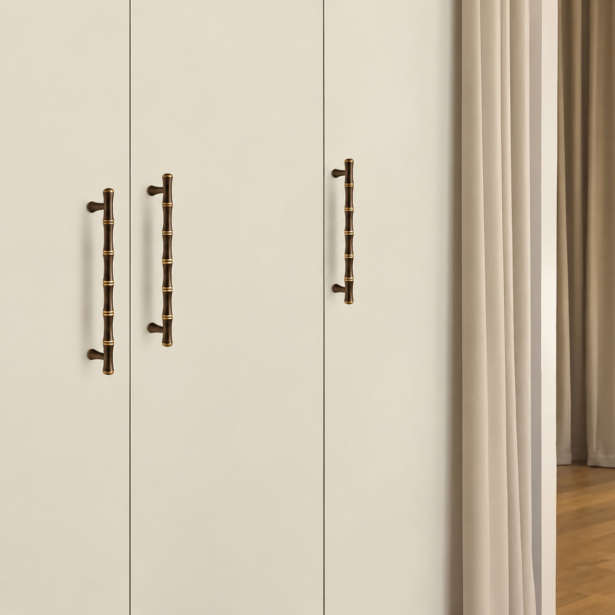 In-use view of segmented dark antique brass bar cabinet pull with gold rings, style #11 (160 mm).