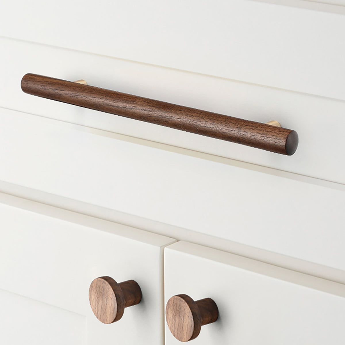In-use view of slim walnut wood bar cabinet pull with gold-colored mounts, style #4 (160 mm).