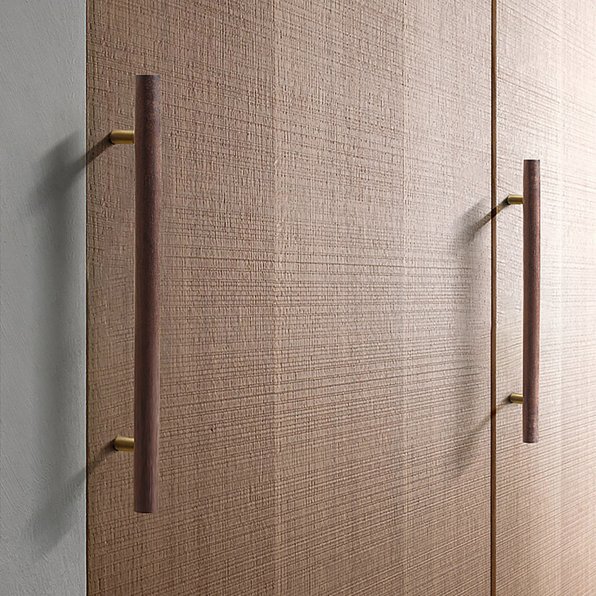 Walnut wood bar cabinet pulls with brass mounts installed on wood cabinet doors.