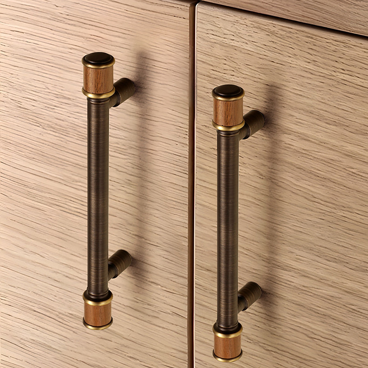 Two dark antique brass bar cabinet pulls with brown end caps installed on wood doors.