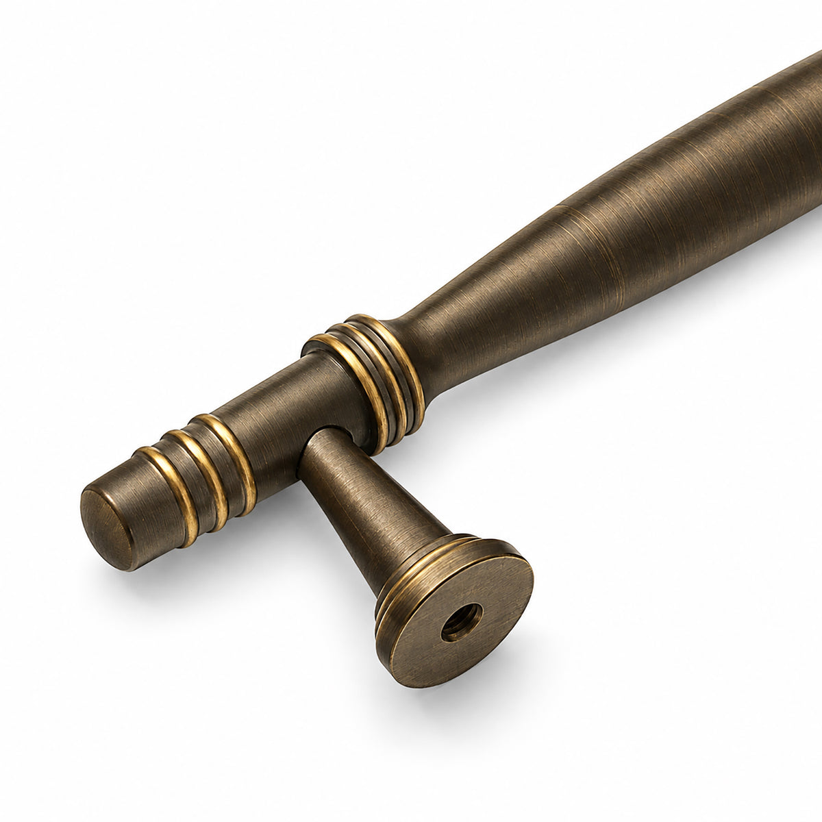 Close view of dark antique brass bar cabinet pull with gold ring details and rear mounting foot.