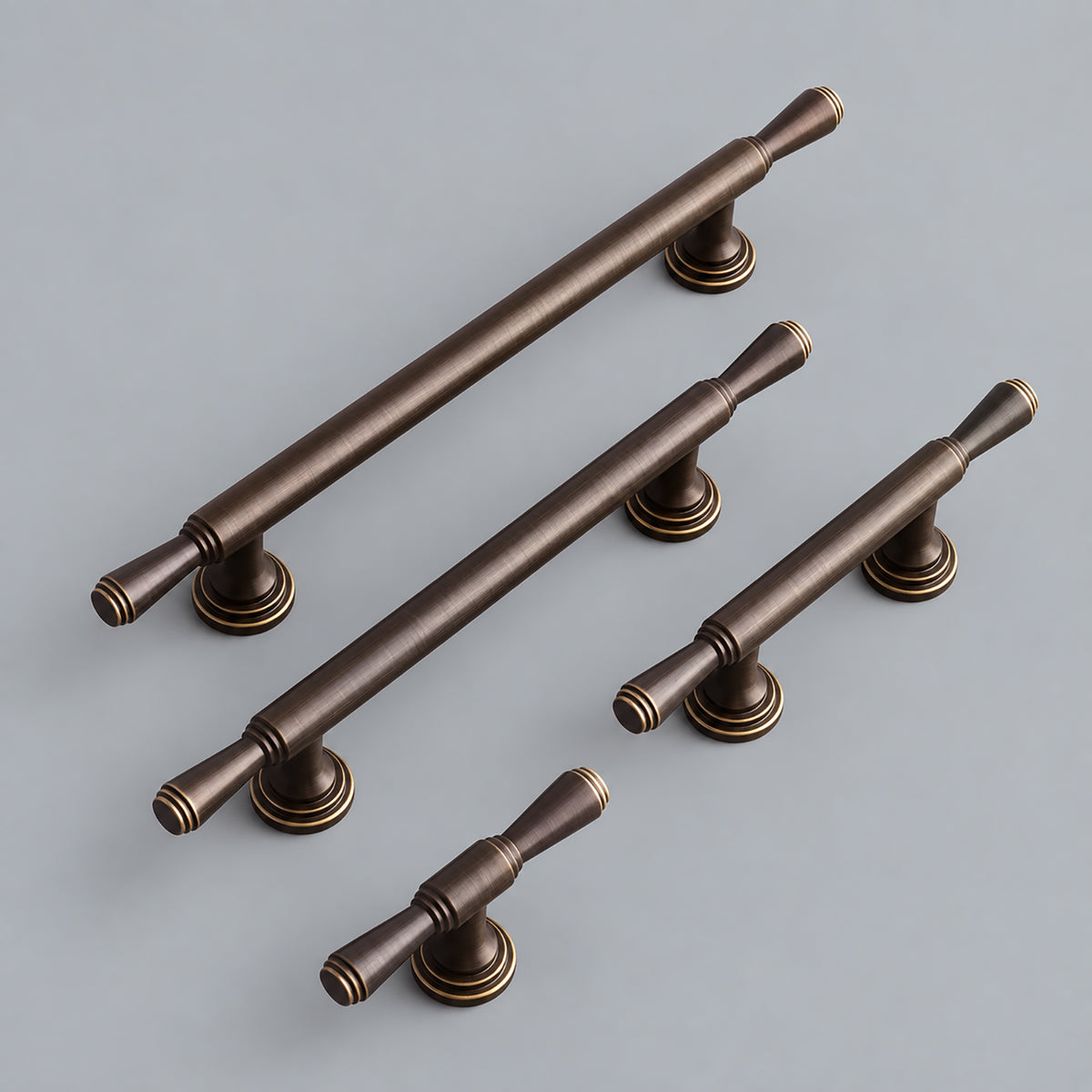 Four lengths of dark antique brass bar cabinet pull with flared ends.