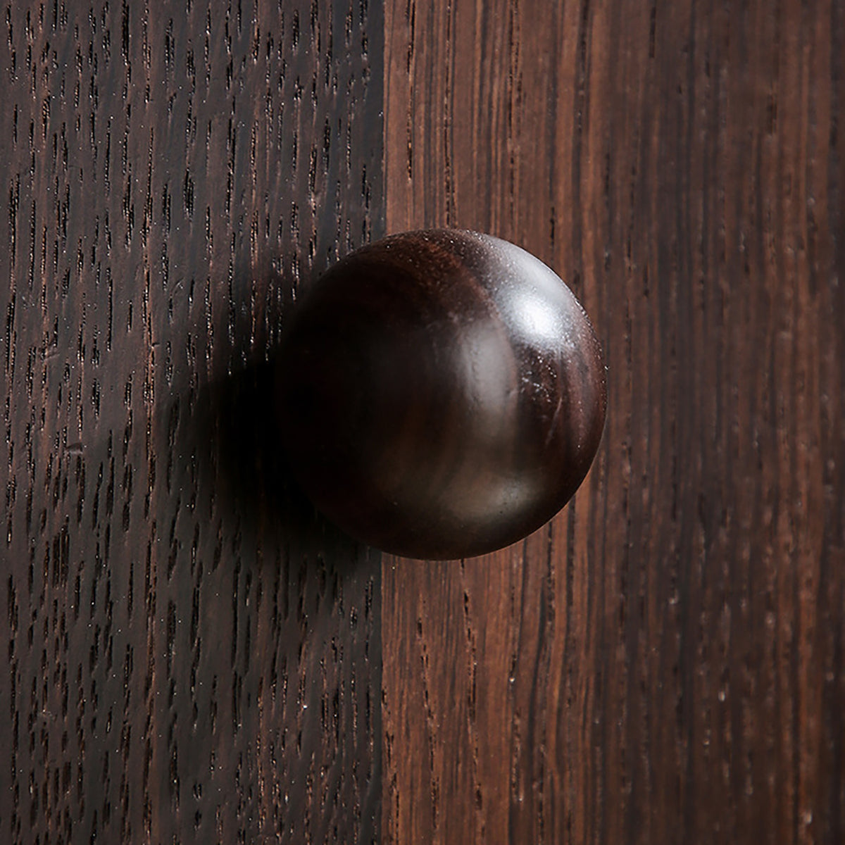 In-use view of round walnut wood cabinet knob, style #1 (40 mm).