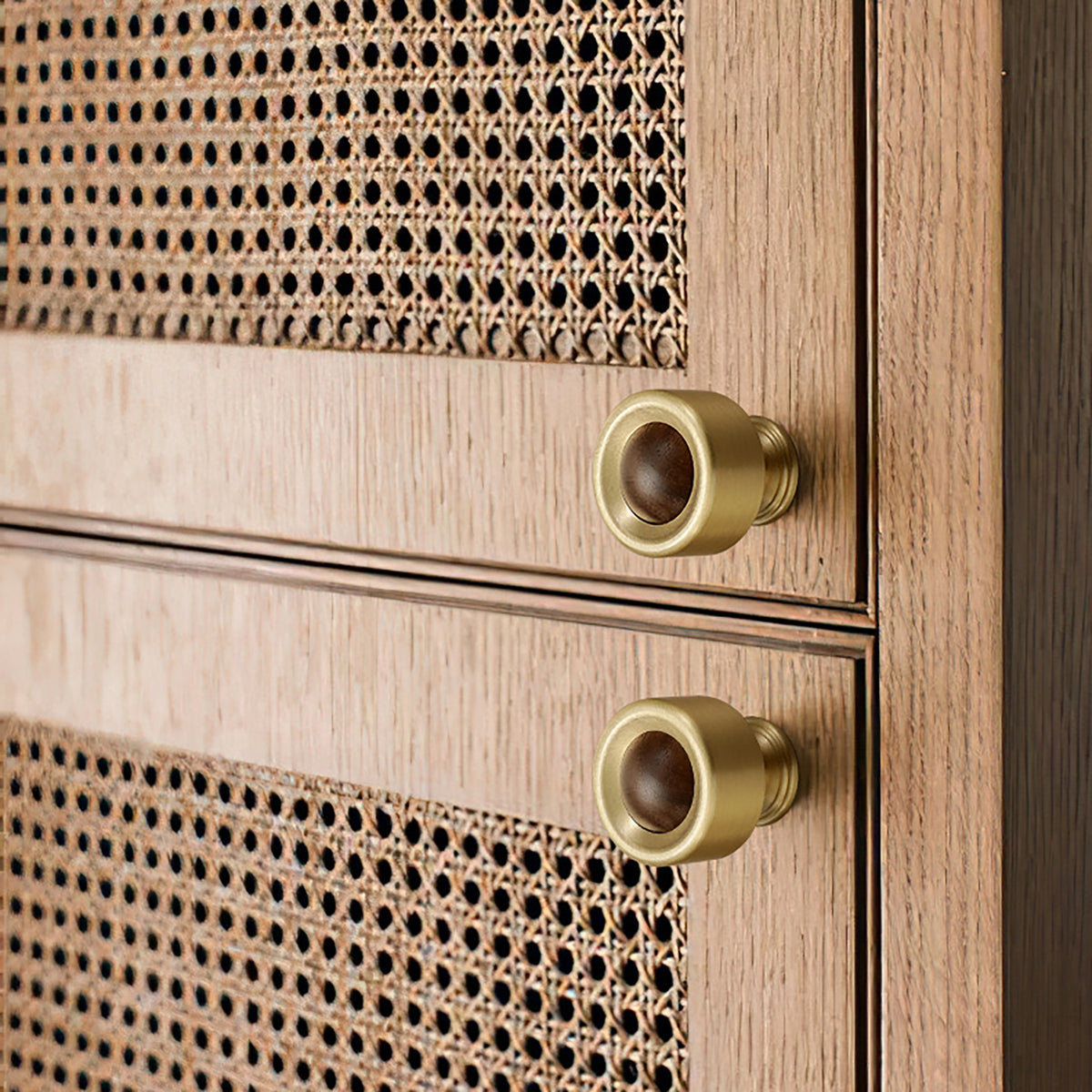 In-use view of brass cup cabinet knob with a dark wood ball inset, style #1.