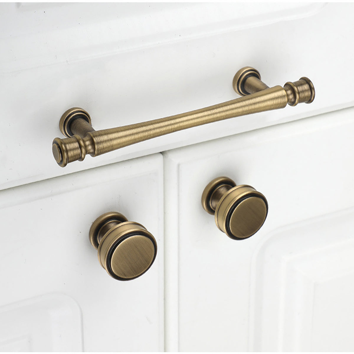 Layered round brass cabinet knob with brushed bronze finish, style #10 installed on furniture.