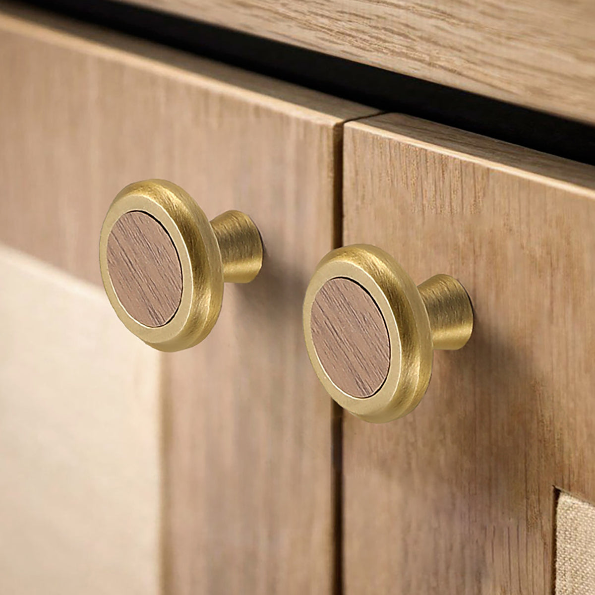 In-use view of flat round brass cabinet knob with dark wood inset, style #16 (28 mm).