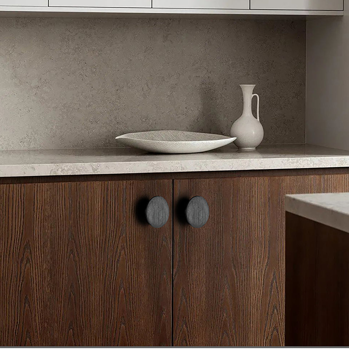 In-use view of flat round black oak cabinet knob, style #2 (48 mm).