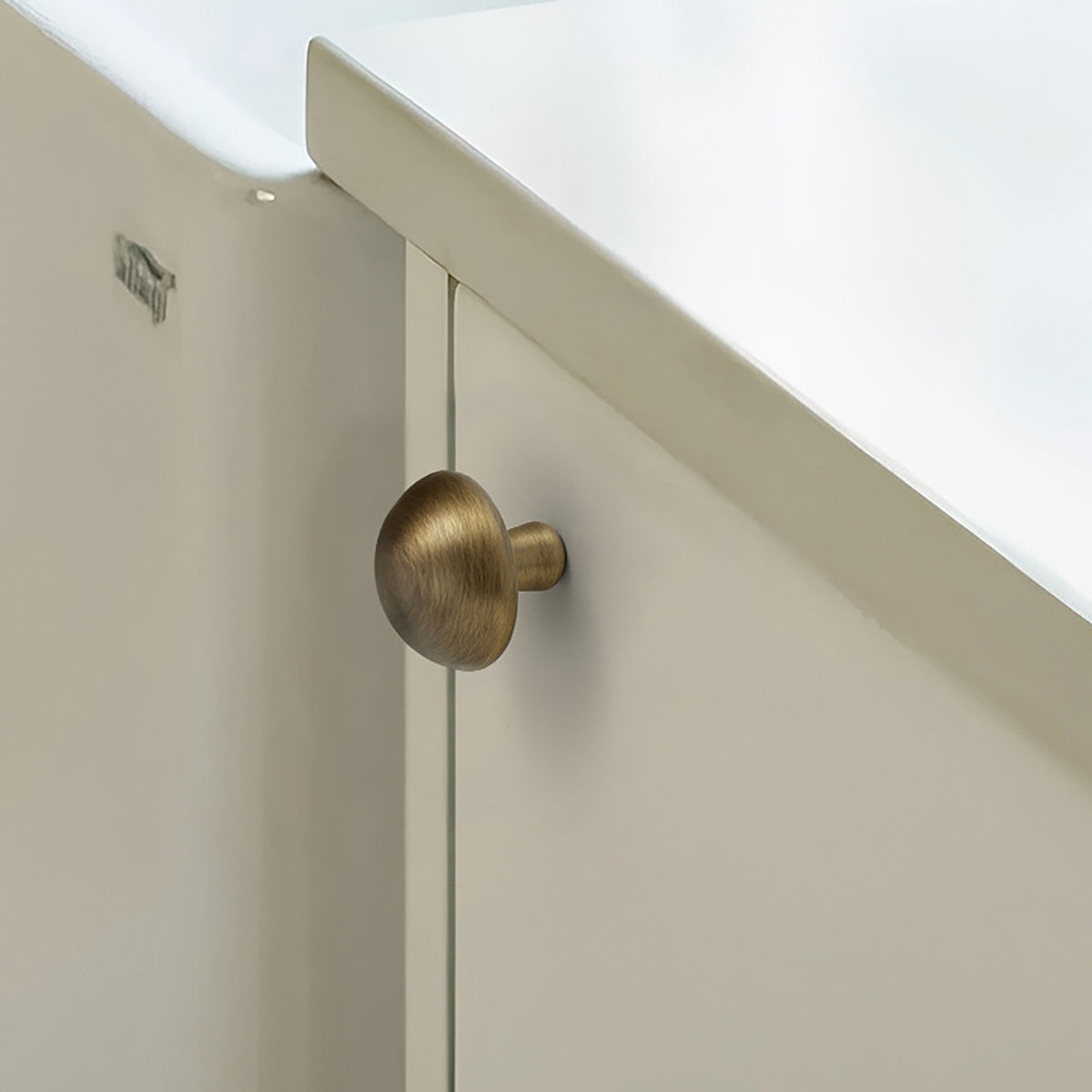 Smooth domed brass cabinet knob with brushed bronze finish, style #2 installed on furniture.