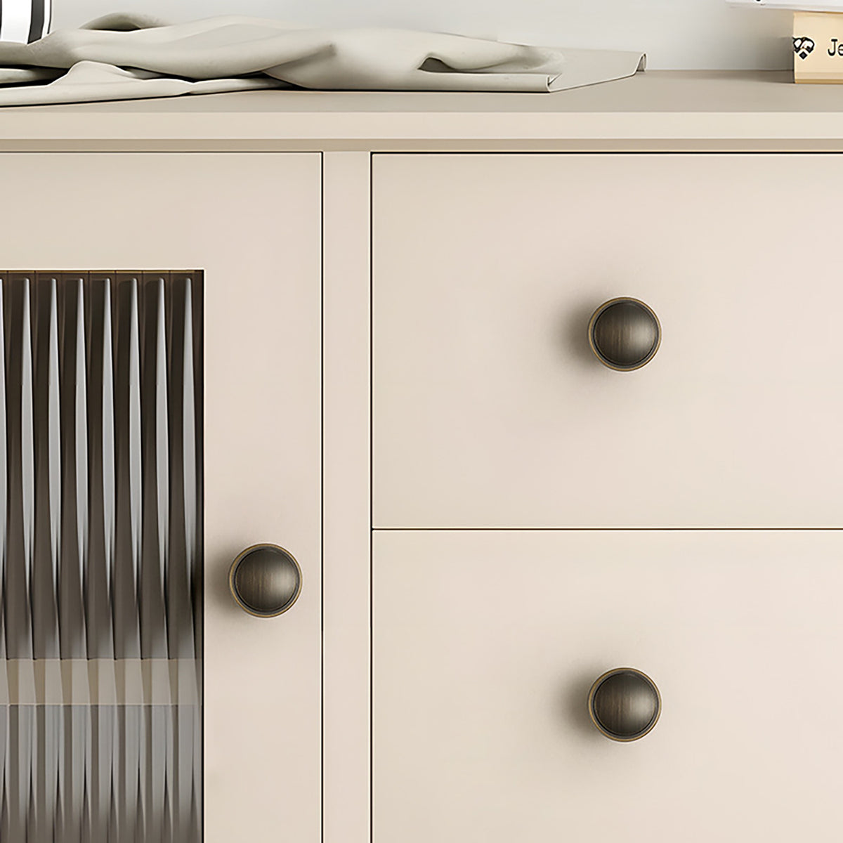 In-use view of shallow cupped antique bronze brass cabinet knob, style #20.