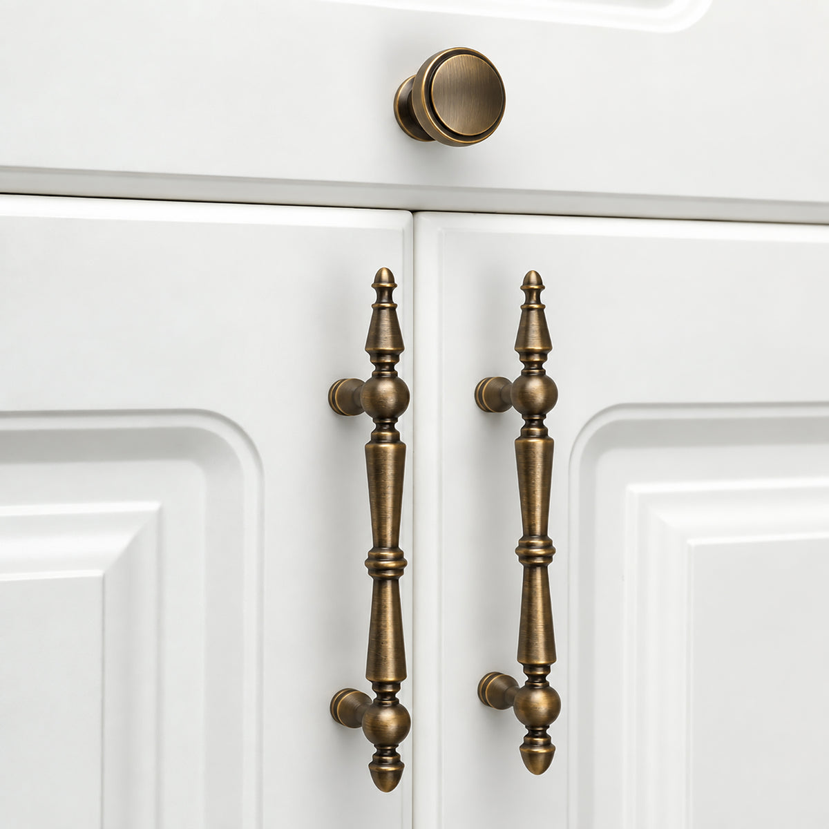 In-use view of recessed round antique bronze brass cabinet knob, style #21.