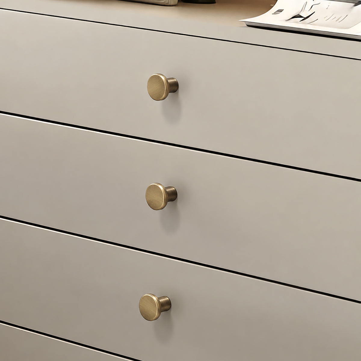 Flat round brass cabinet knob with brushed bronze finish, style #3 (20 mm option) installed on furniture.