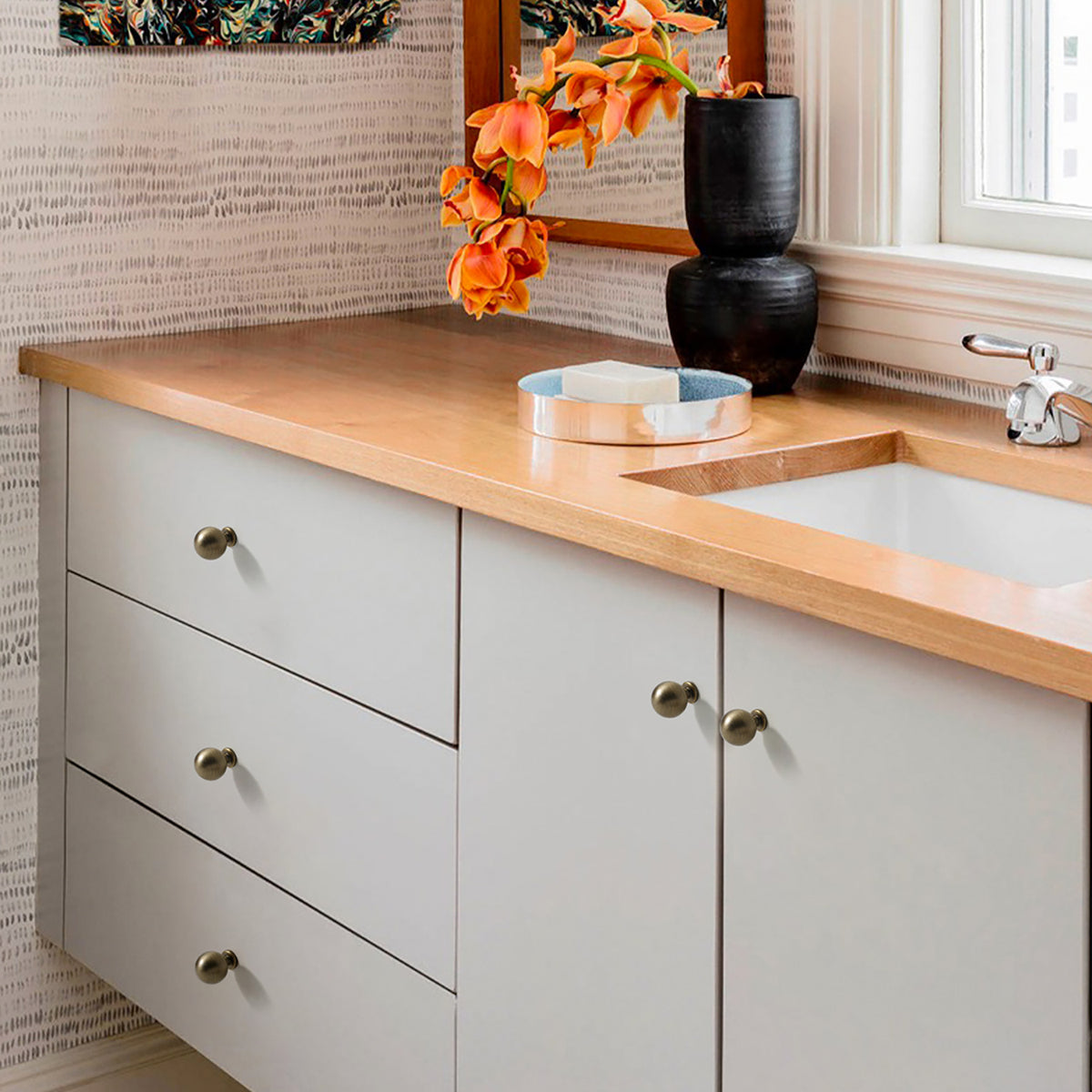 Spherical brass cabinet knob with brushed bronze finish, style #4 (20 mm option) installed on furniture.