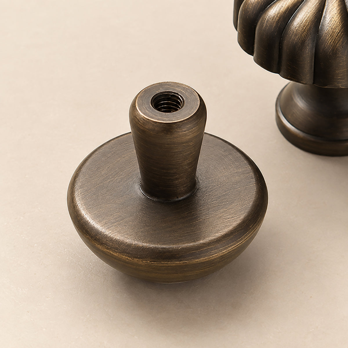 Additional angle of bronze-finish solid brass round cabinet knob, style #4.