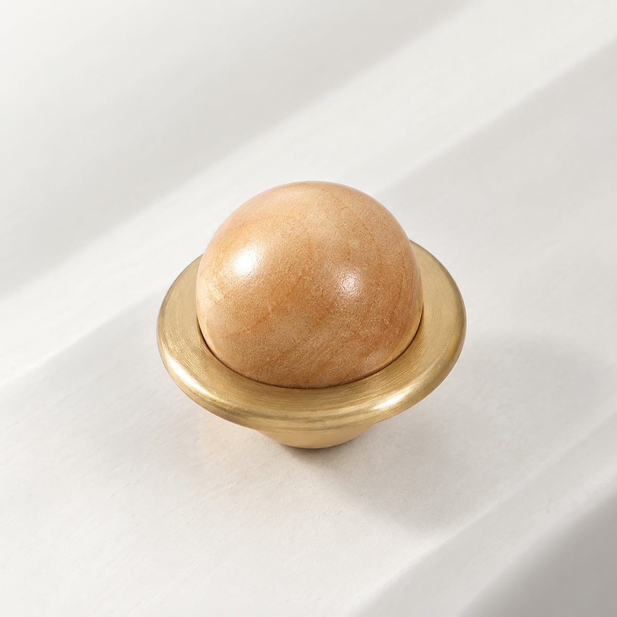 Side and mounting view of light wood half-ball cabinet knob set in a brass cup, style #4.