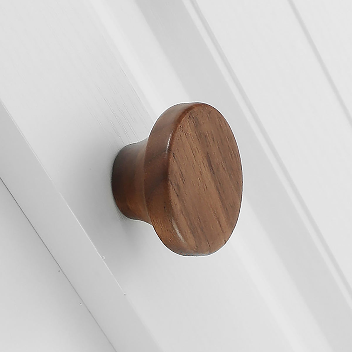 In-use view of walnut wood mushroom cabinet knob with a flat round top, style #4.