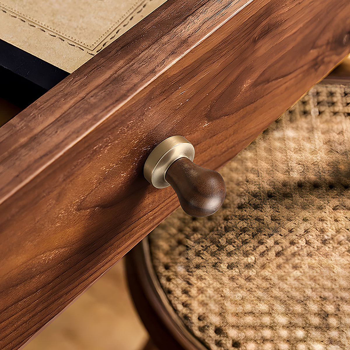 In-use view of rounded walnut wood cabinet knob with brass base, style #5.