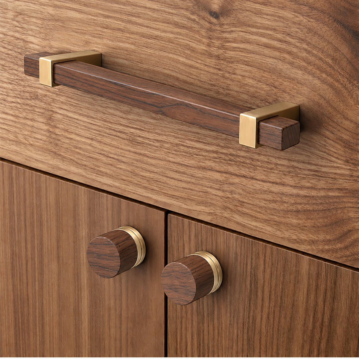In-use view of walnut wood cylindrical cabinet knob with brass base, style #6.