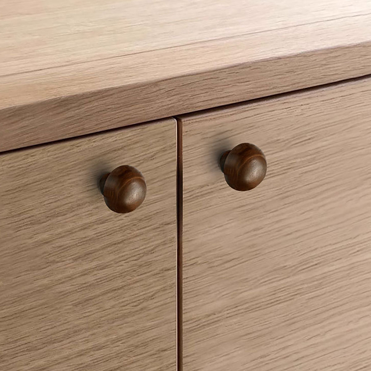 In-use view of dark walnut wood domed cabinet knob, style #6.