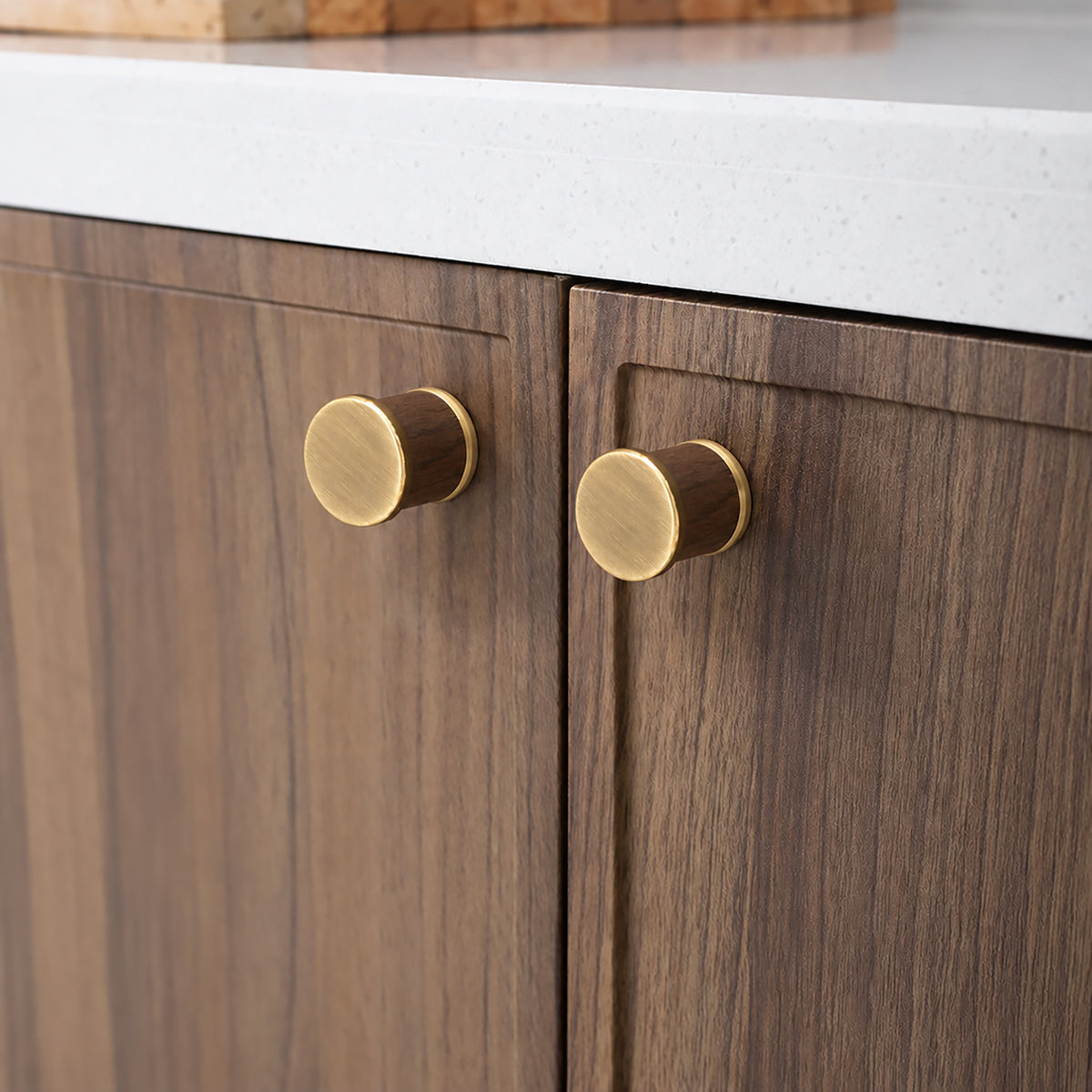 In-use view of dark wood barrel cabinet knob with brass end caps, style #7 Brass.