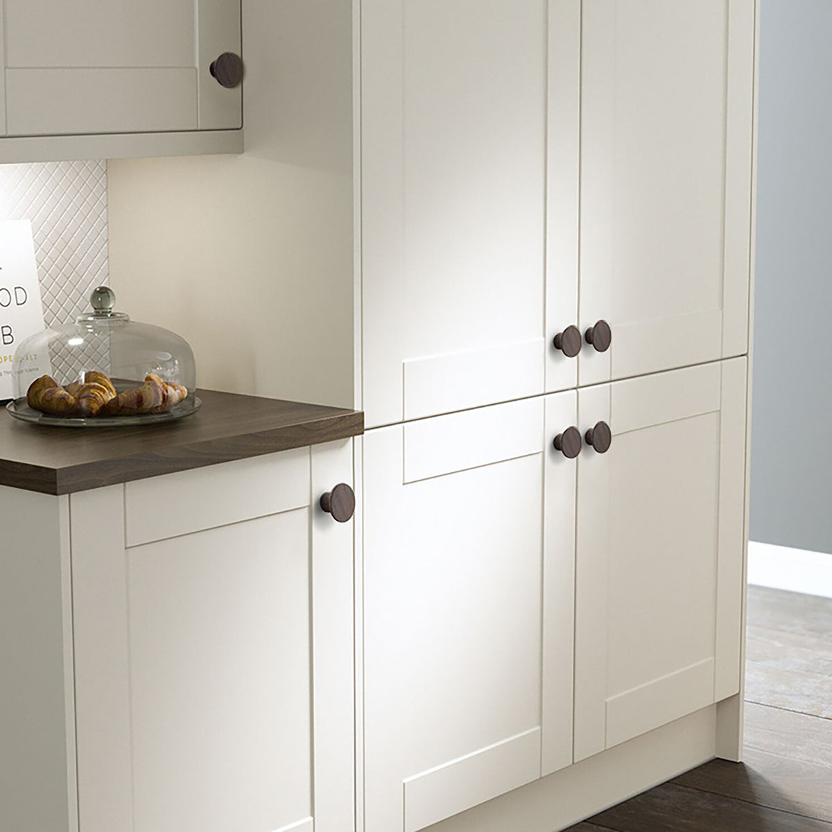 Flat round walnut cabinet knob, style #7 shown in a styled setting.
