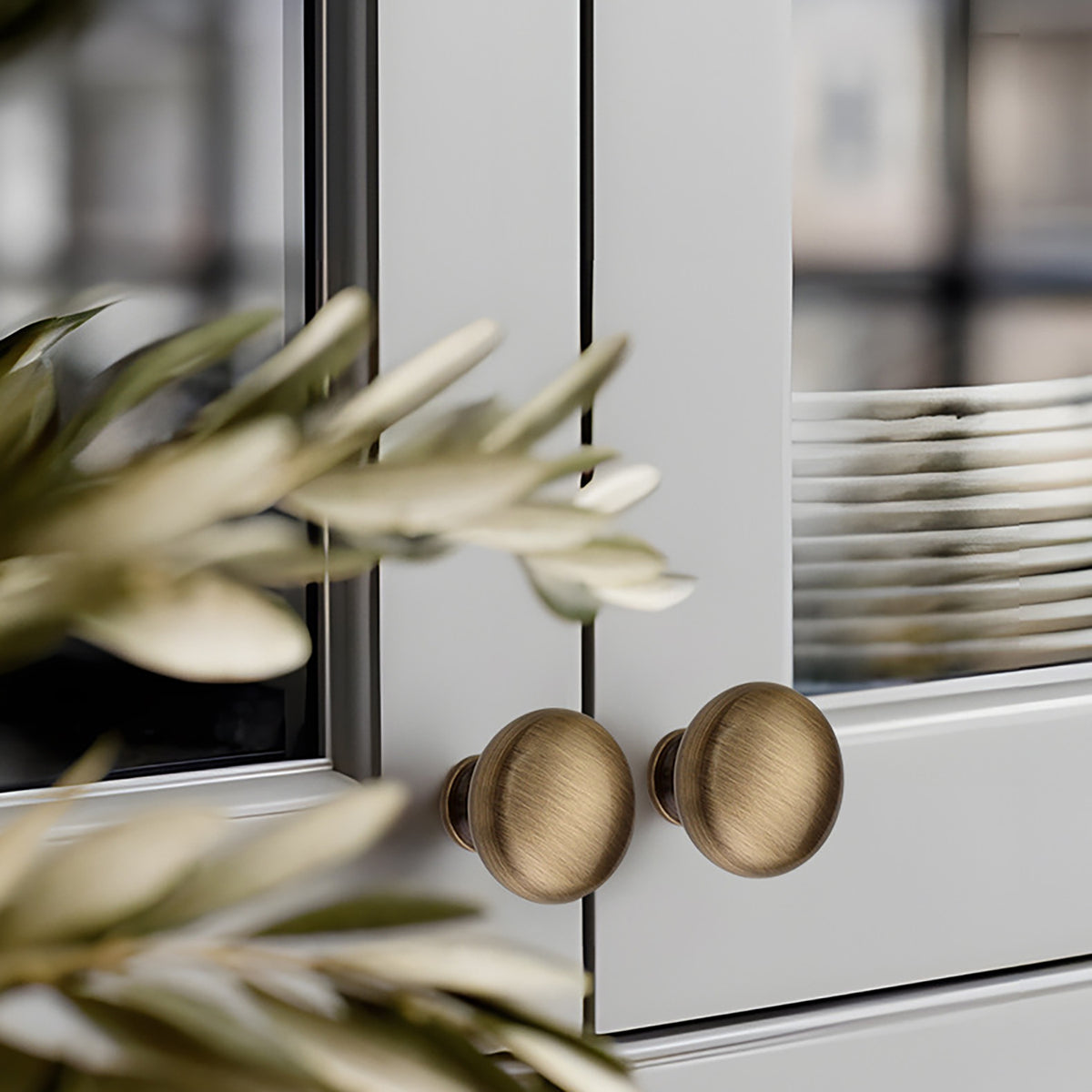 Domed mushroom brass cabinet knob with brushed bronze finish, style #9 (25 mm option) installed on furniture.