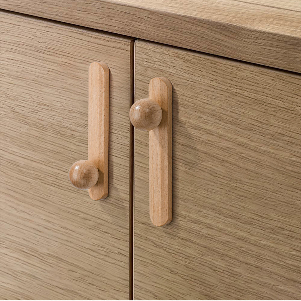 Beech wood cabinet knobs installed on wood cabinet doors.