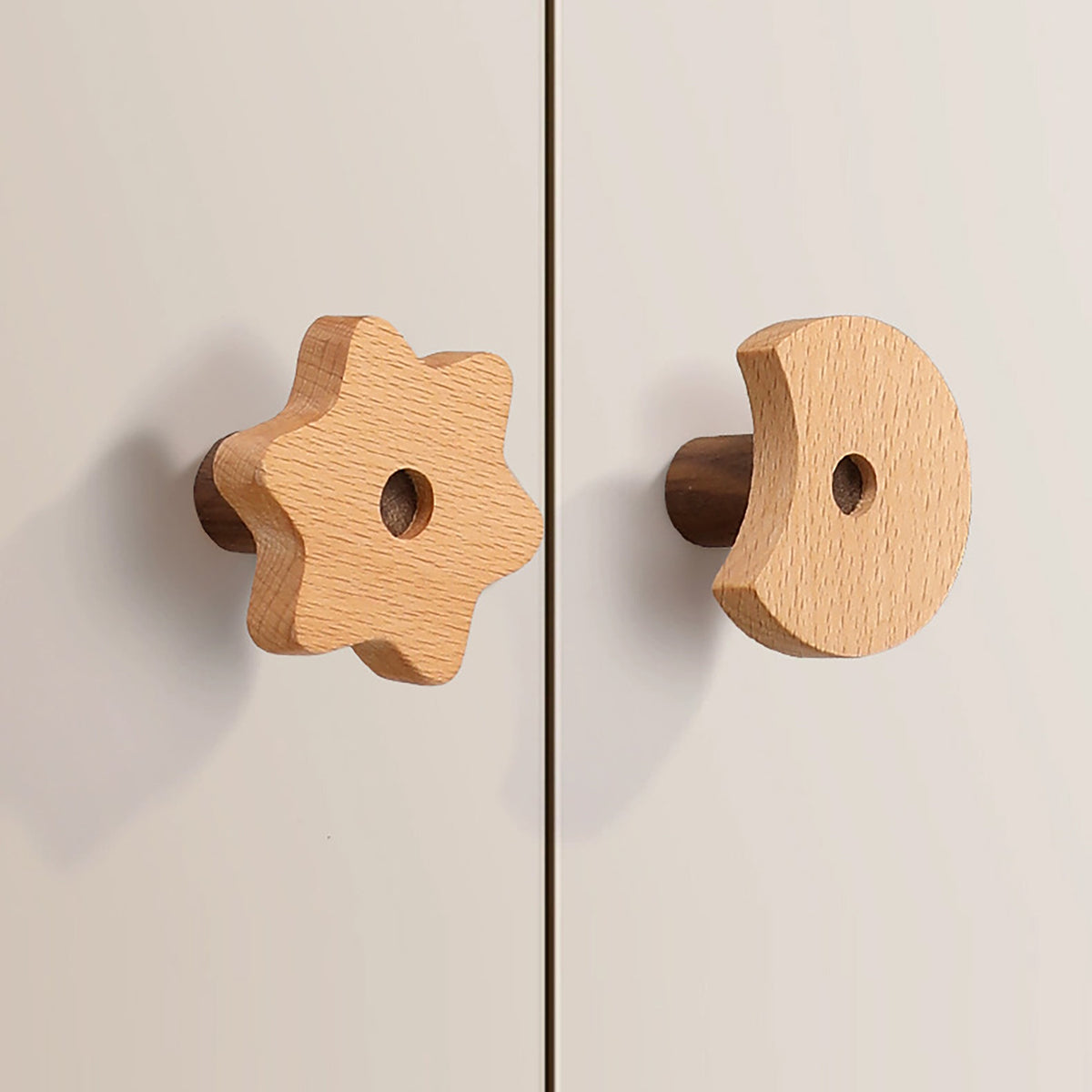 Flower-shaped and curved wood cabinet knobs fitted to white cabinet doors.