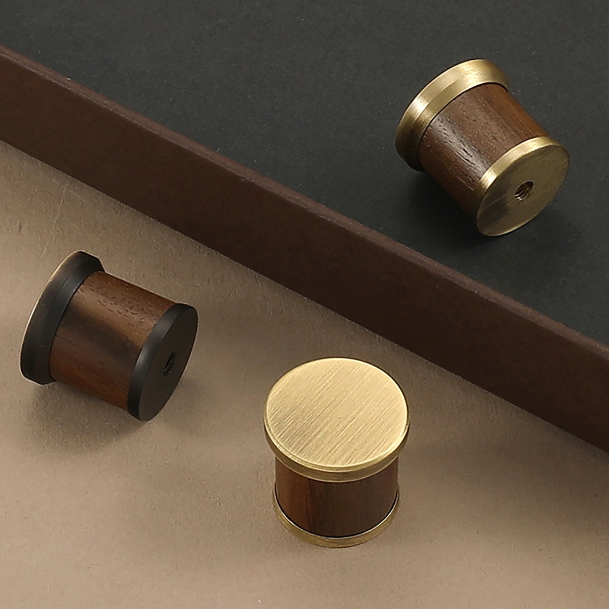 Three dark wood barrel cabinet knobs with brass, bronze and coffee-finish end caps, showing front and mounting side.