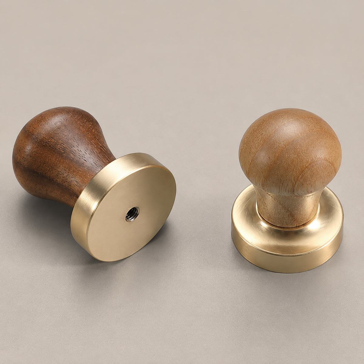 Two dark wood ball cabinet knobs on brass pedestals, showing front and rear mounting views.