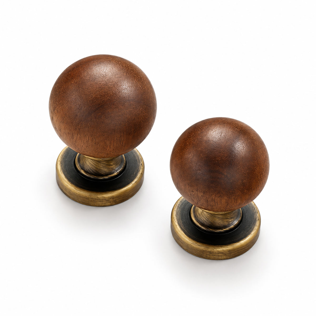 Two walnut wood ball cabinet knobs with dark bronze bases on a white background.
