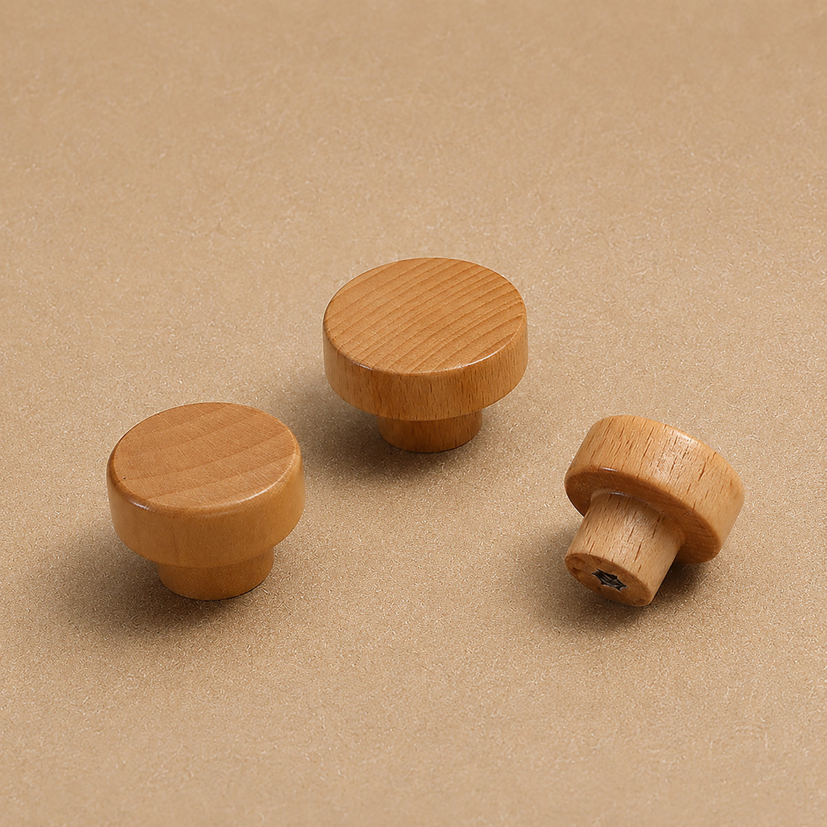 Light wood mushroom cabinet knobs, showing front and rear mounting holes.