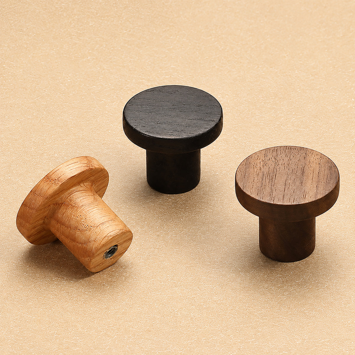 White oak, black oak and walnut round cabinet knobs, showing back mounting holes.