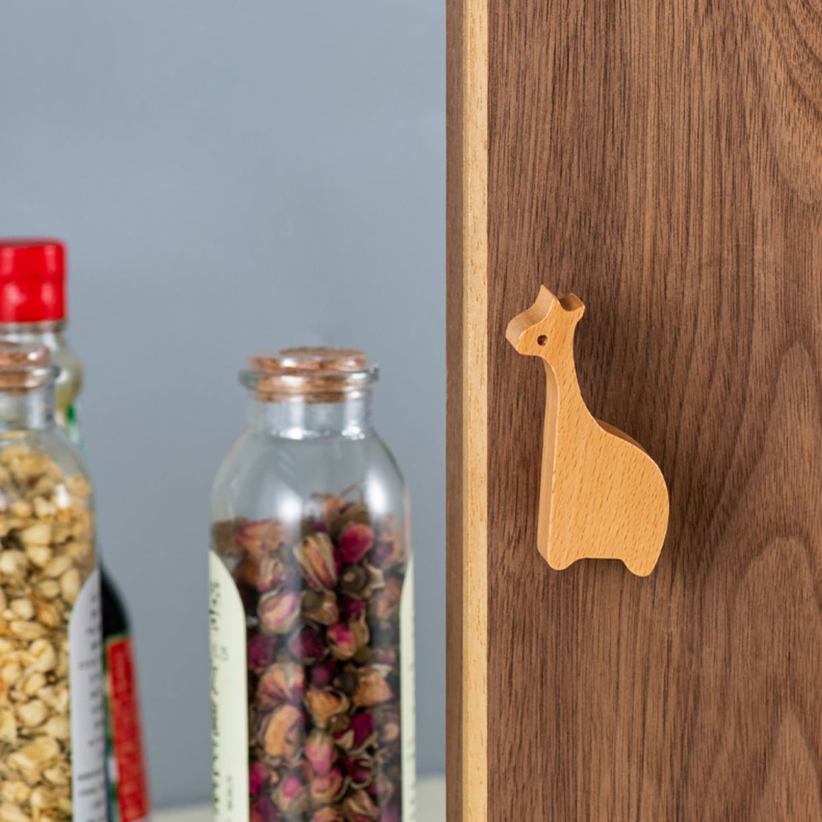 Giraffe-shaped wood wall hook mounted on a wood panel.