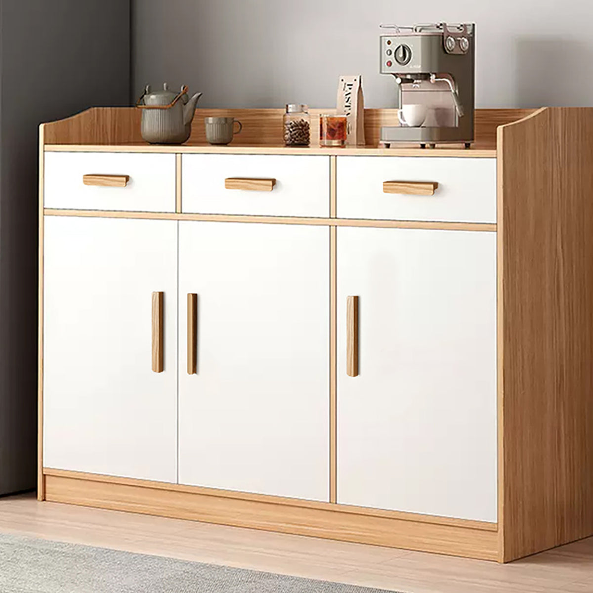 Oak wood finger pulls fitted to the drawers of a white cabinet.