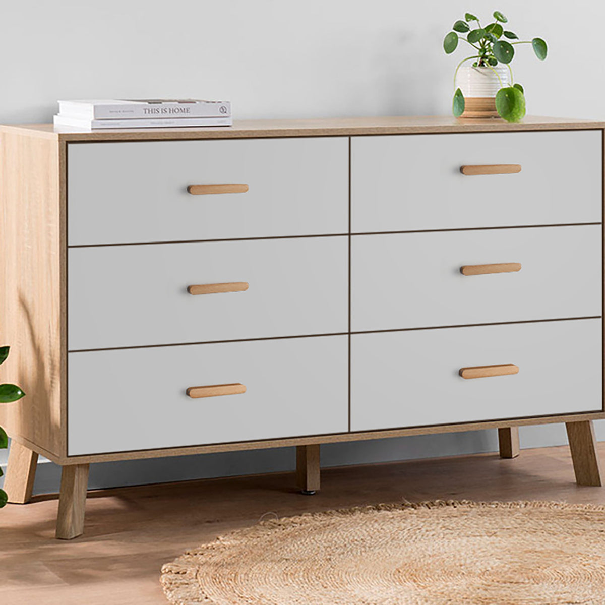 Beech wood finger pulls installed horizontally on a gray chest of drawers.