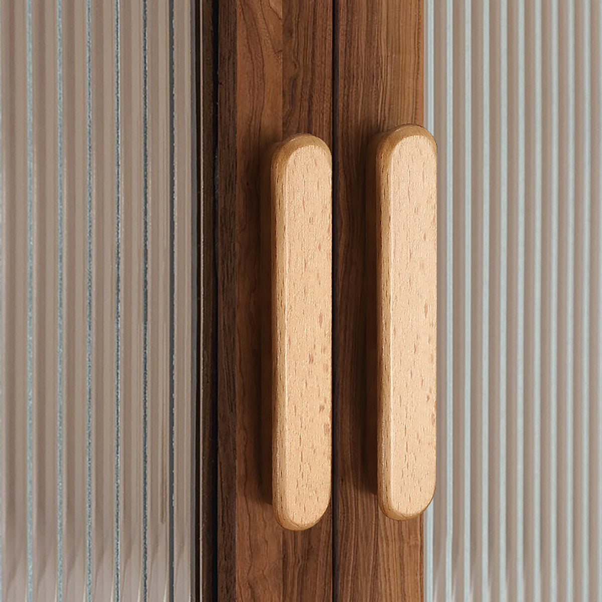 In-use view of slim rounded beech wood finger pull, 128 mm option.
