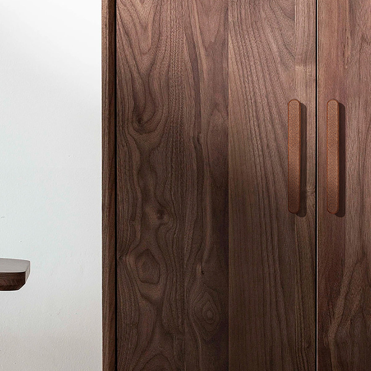 In-use view of slim rounded reddish wood finger pull, 192 mm option.